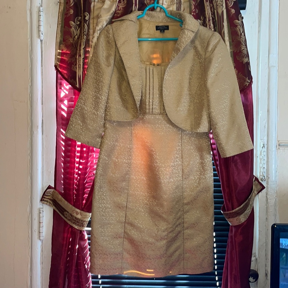A Beautiful Gold dress with a short Gold Jacket . Slightly wear